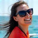 Sarah Lim smiling cheerfully aboard an AquaGlimmer fishing boat, enjoying the sun